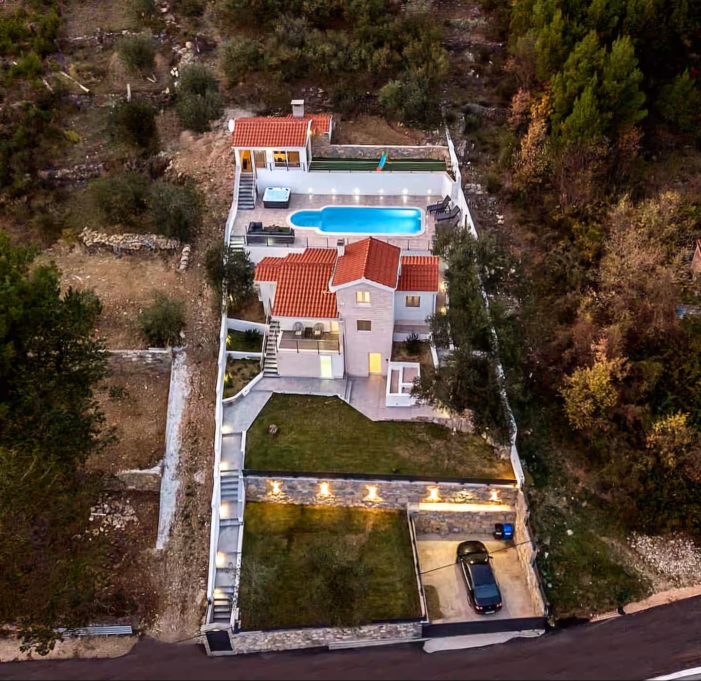 Evening aerial view of the full Villa Carica estate